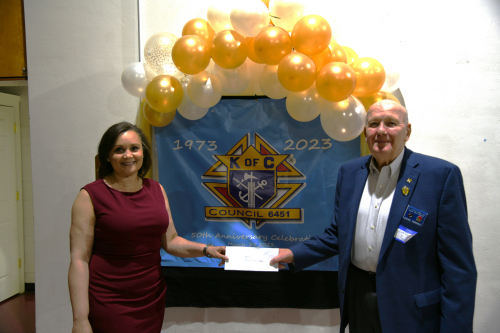 Alicia Wilson of the J Iverson Riddle Developmental Center accepts the L.A.M.B. funds from District Deputy and L.A.M.B. Chair for Council 6451 Steve Purcell